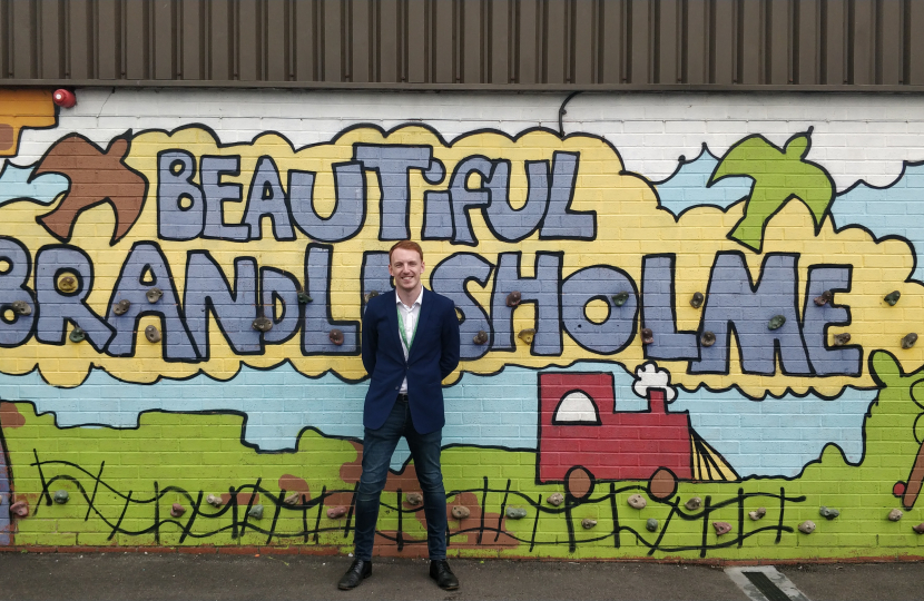 Cllr Rydeheard at the 'Beautiful Brandlesholme' climbing wall in the playground at Woodbank Primary School